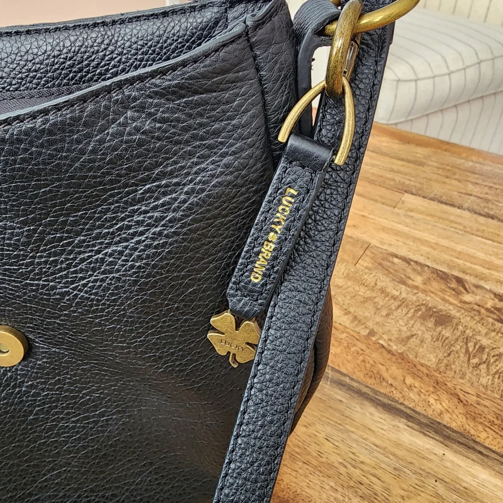 Lucky Brand black leather purse with magnetic tassle closure. It is 10"x10". - Picture 4 of 7